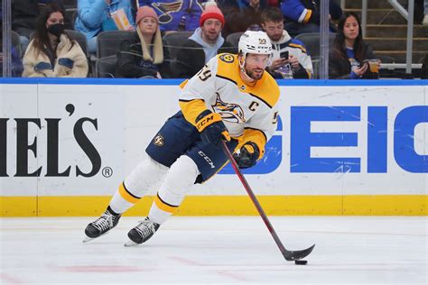 Roman Josi, captain of the Predators, defending against an opposing player.