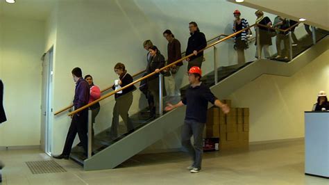 San Francisco residents evacuate a high-rise building following Friday's tremor.
