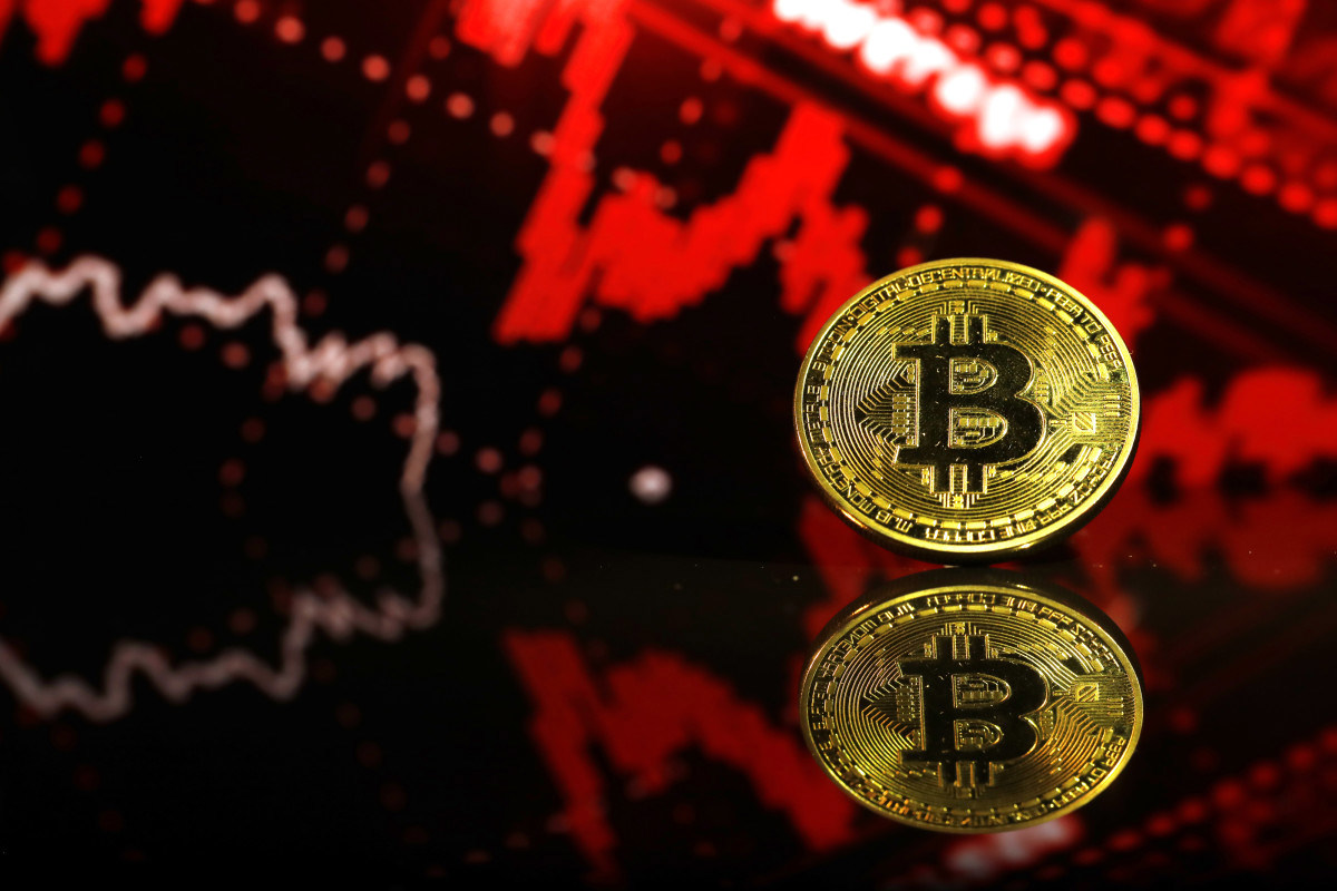 Investor monitoring cryptocurrency market data amid Bitcoin's significant price decline.