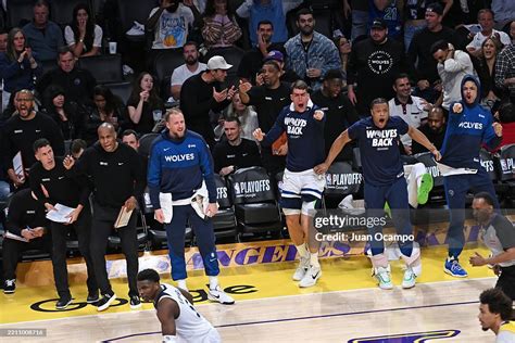 The Timberwolves bench celebrates during their game against the Warriors, showing the team camaraderity.
