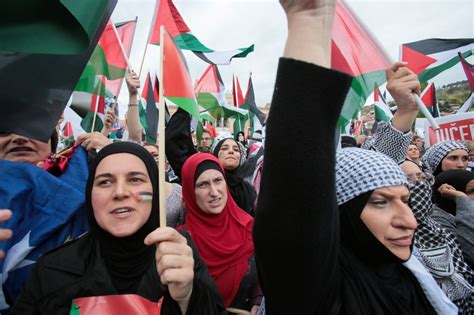 Bosnian women hold photos of Palestinians killed in Gaza during a solidarity march in Sarajevo.