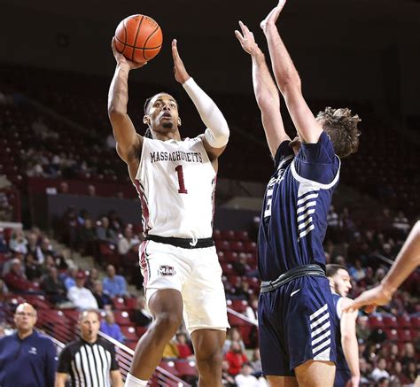 Eagles' veteran guard Donald Hand Jr. looks to create offense against Davidson's defense.