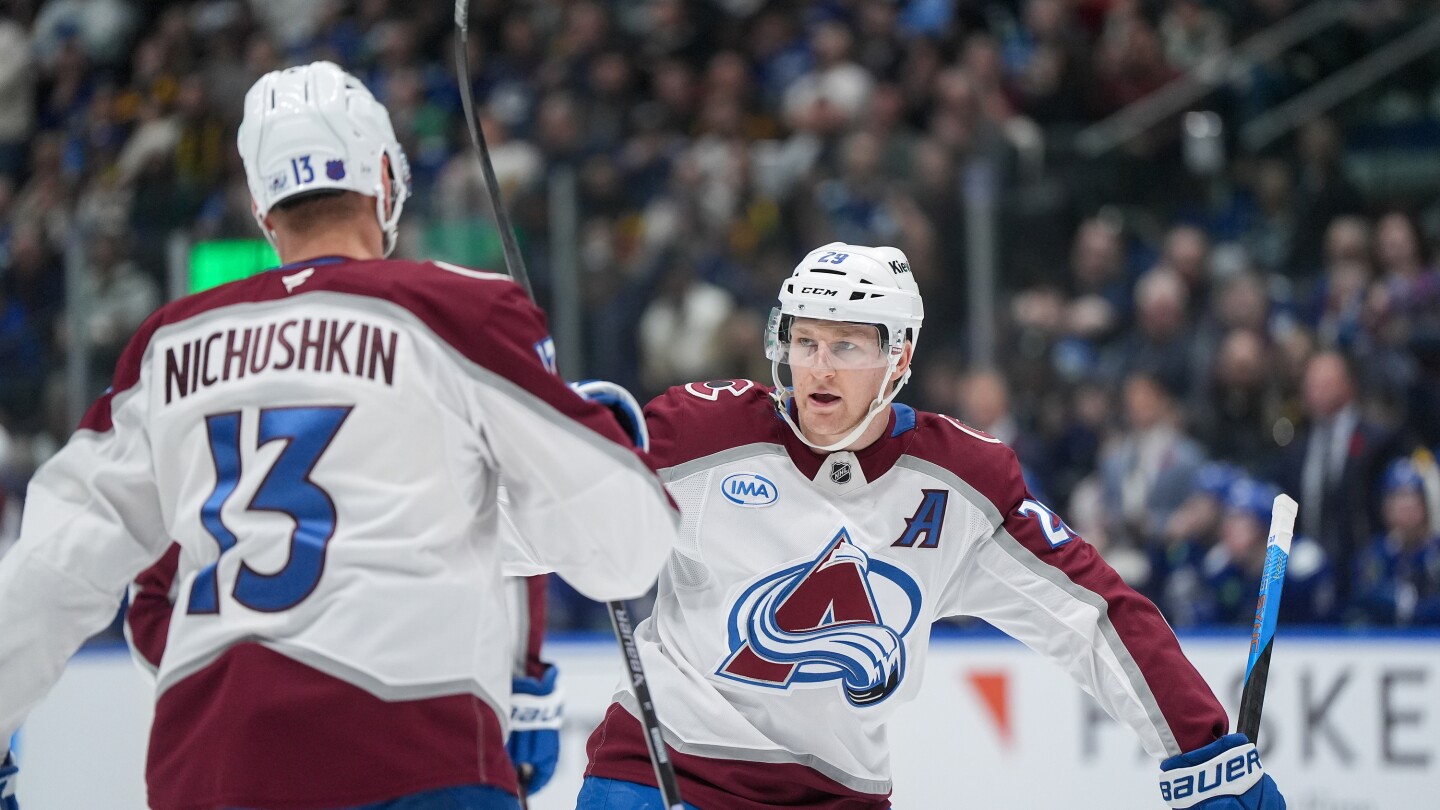 Nathan MacKinnon celebrates one of his two goals against the Canucks.