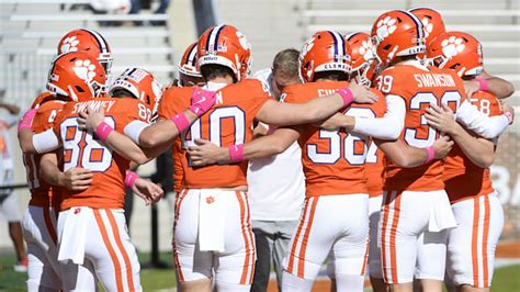 Clemson players huddle during a practice session at Memorial Stadium.