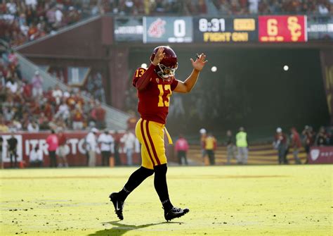 A quarterback in action during a college football game.