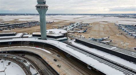 Travelers wait at Chicago O'Hare, where over 930 flights were canceled due to snow.