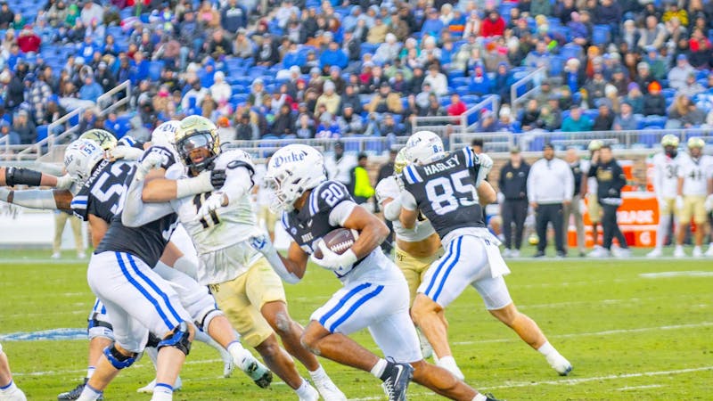 Quarterback Darian Mensah throws a touchdown pass against Wake Forest, setting Duke's single-season record.