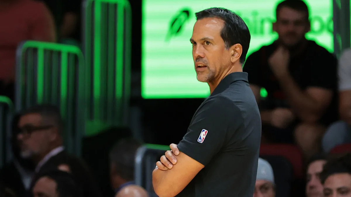 Heat coach Spoelstra monitors the game from the bench.