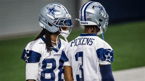 CeeDee Lamb and George Pickens on the Cowboys sideline during a game.