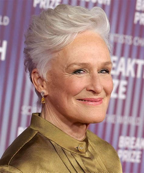 Glenn Close at a recent event, displaying her signature sophisticated gray pixie cut that fans have come to recognize.