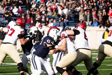 Players from Harvard and Yale exchange handshakes after The Game, a tradition dating back to 1875.