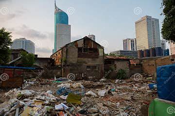 The stark contrast between modern high-rises and informal settlements in Jakarta.