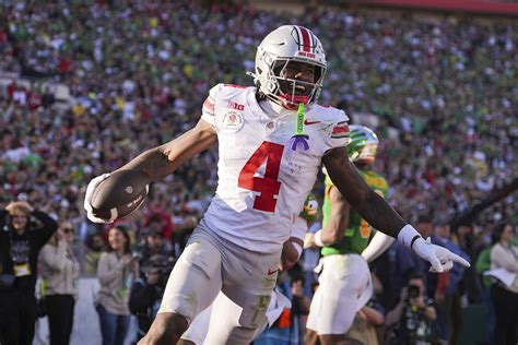 Jeremiah Smith receives medical attention on the sideline during Ohio State's game against UCLA.