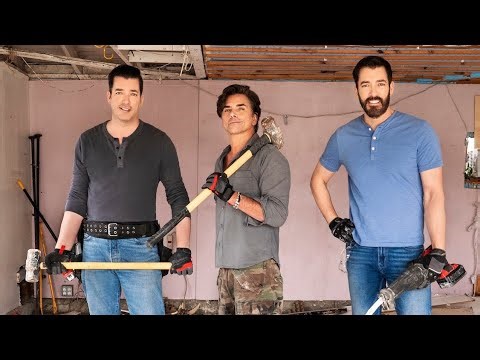 Jonathan Scott shares a laugh with John Stamos during a demolition scene.