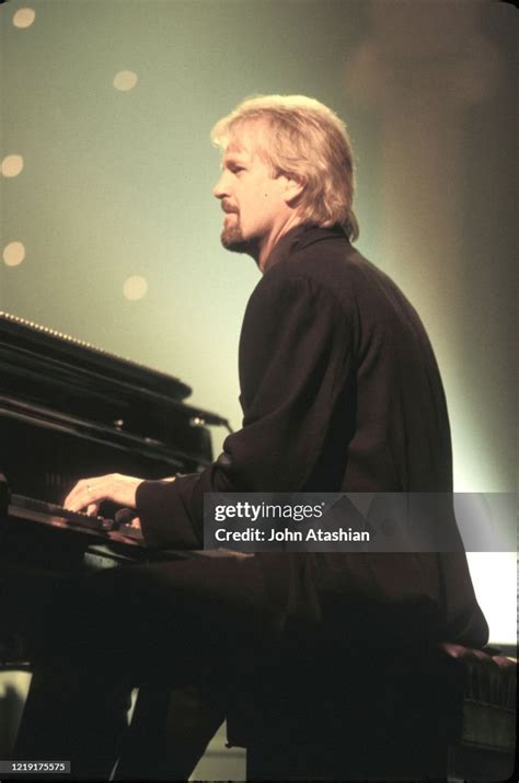 John Tesh performing, finding strength and purpose in music during his cancer battle.