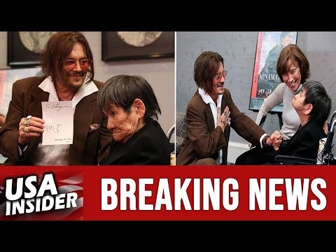 Johnny Depp shares a meaningful moment with Shinobu Sakamoto, a Minamata disease survivor, in Tokyo.