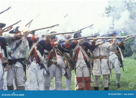 Historical reenactors demonstrating battlefield tactics from the American Revolutionary War period