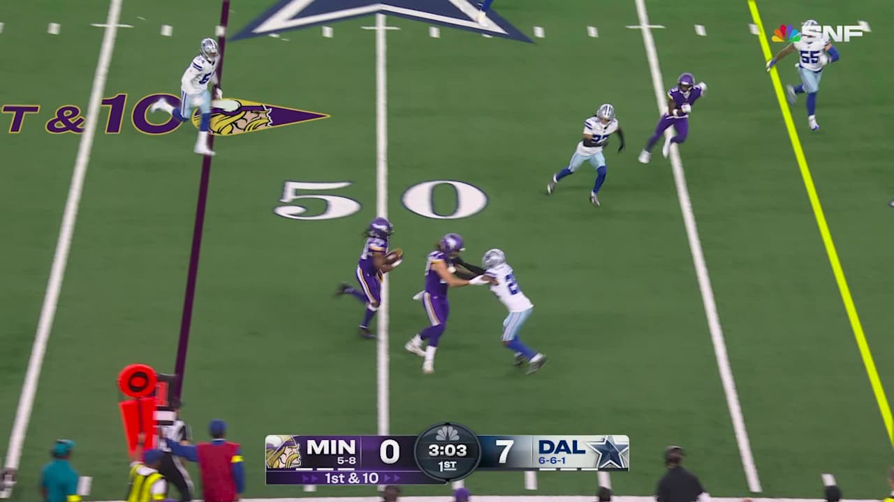 Running back Aaron Jones Sr. breaking a tackle during a run against the Dallas Cowboys defense.