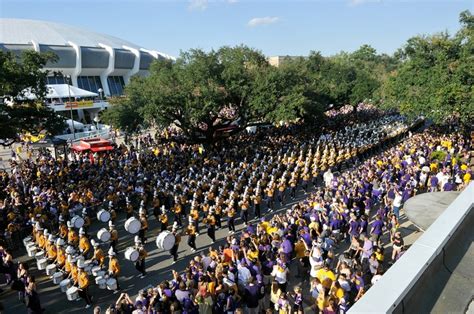 LSU players walk down Victory Hill with the flag before the Battle for the Boot.