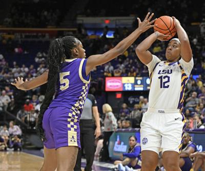 LSU guard Flau'Jae Johnson drives past a defender during a game.