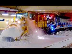 MTA workers clearing snow from subway tracks in New York City.