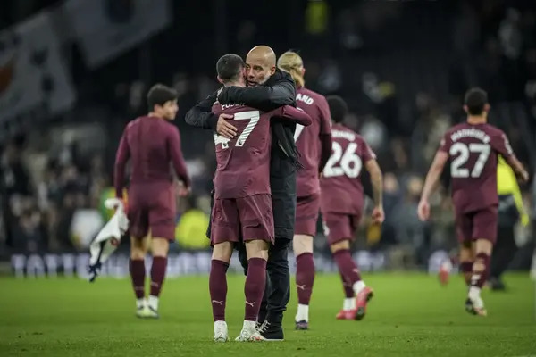 Guardiola celebrates with his Manchester City squad after winning the Premier League