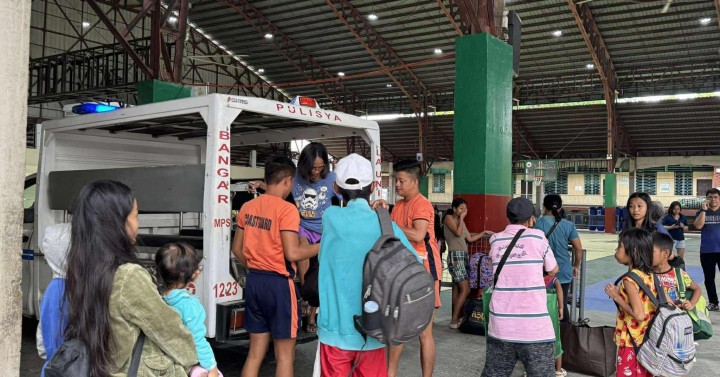 Evacuees take shelter in a sports center in Aurora province.