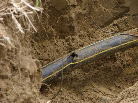 Utility workers repairing the 4-inch gas line that was struck by an excavator.