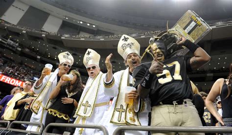 Saints fans revel in a memorable Thanksgiving victory moment, embodying team spirit.