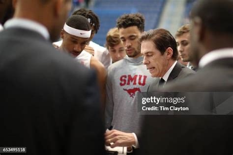 Coach Tim Jankovich directing players during a high-stakes AAC matchup.