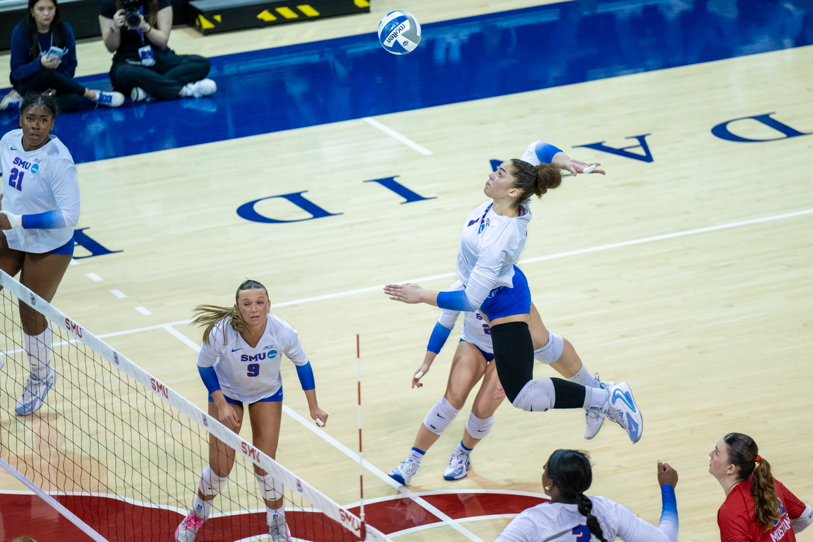 Energetic SMU supporters rallying behind their team during a critical play.
