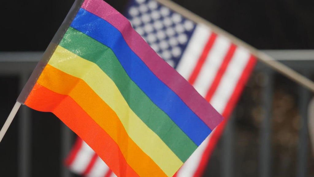 A same-sex couple celebrates their marriage, highlighting the personal stakes of the Supreme Court review.