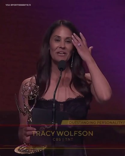 Wolfson relaying information to the broadcast booth during an NFL game.