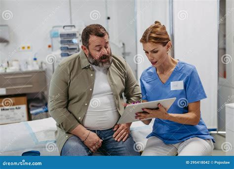 A healthcare professional discussing treatment options with a patient in a clinical setting.