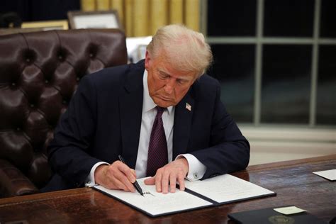 President Donald Trump signing a pardon proclamation in the Oval Office.