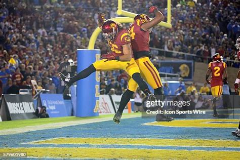 Trojans celebrate during their record-setting 114-point performance against Manhattan.