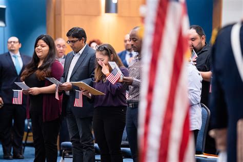 Immigrants taking the Oath of Allegiance during a naturalization ceremony.
