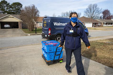 A Walmart delivery driver loads packages for Express Delivery on Christmas Eve.