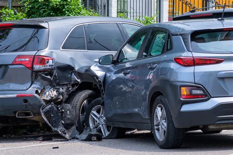 A car accident scene with a sign indicating legal advice is available for victims.