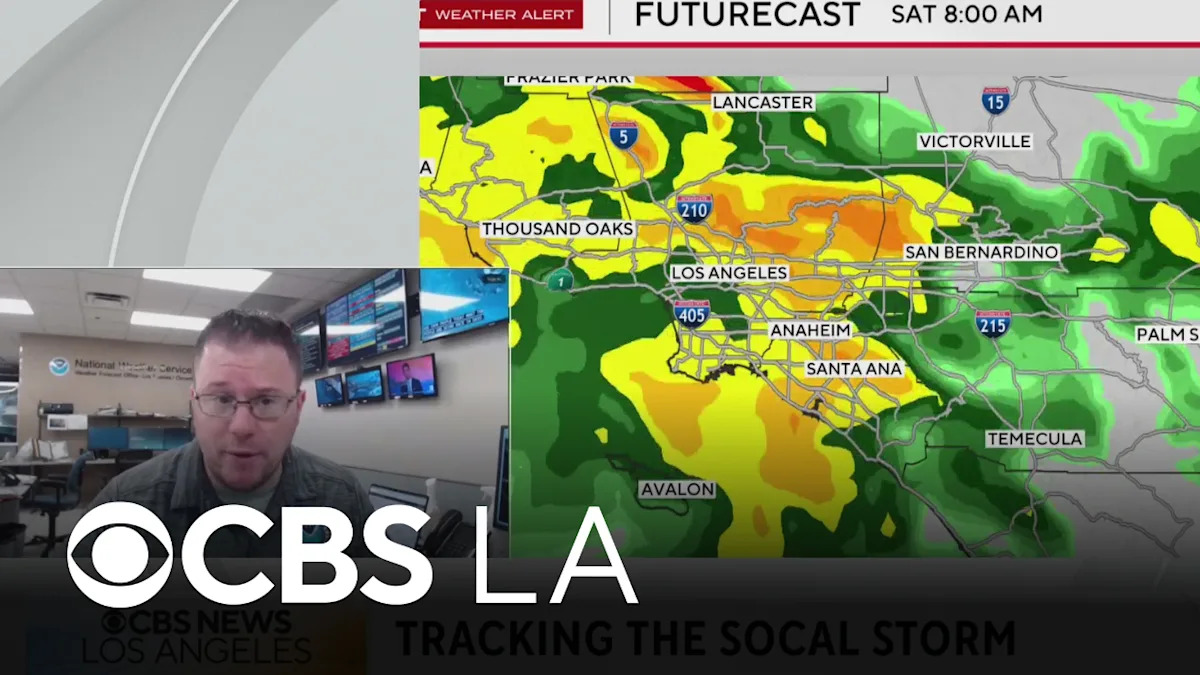 Meteorologist monitoring weather patterns during a winter storm warning.