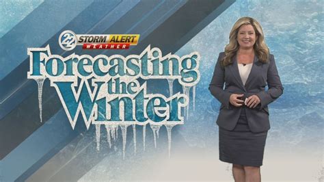 Meteorologist presenting a winter storm forecast on live television.