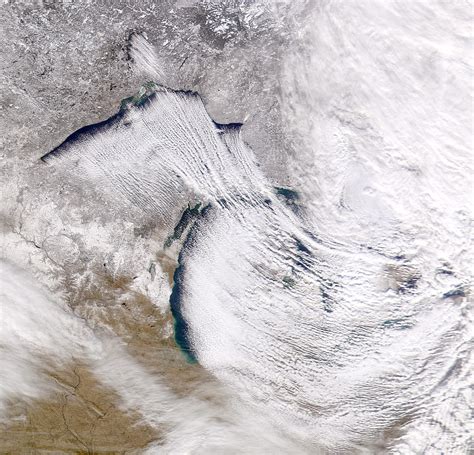 Satellite imagery showing intense lake-effect snow bands forming over the Great Lakes.